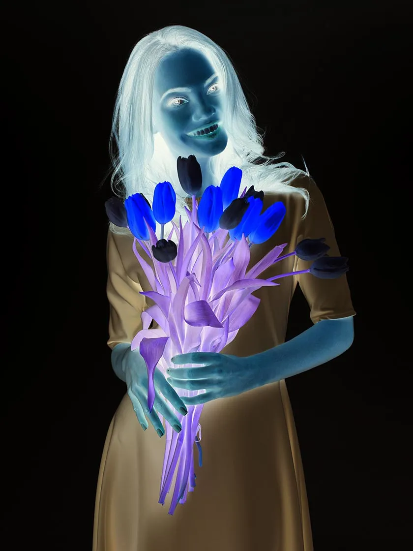 A woman holding a bouquet of flowers, with colors inverted