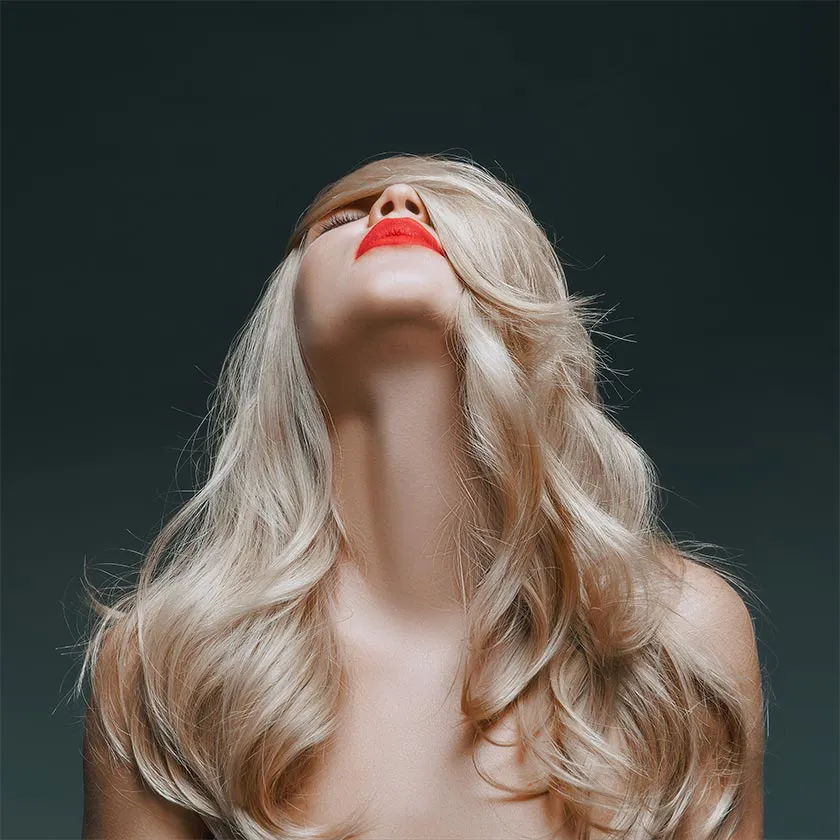 A blonde woman looking upward, original colors